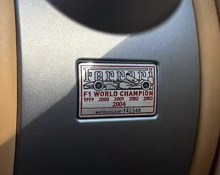 Genuine OEM FERRARI 69065010 FERRARI CHAMPIONSHIP F1 DEL MONDO 2004 PLATE BADGE Emblem New