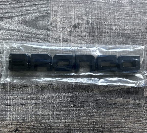 Genuine OEM NOS 1987 1988 1989 1990 1991 FORD BRONCO FRONT FENDER EMBLEM IN GLASS BLACK E7TZ16720
